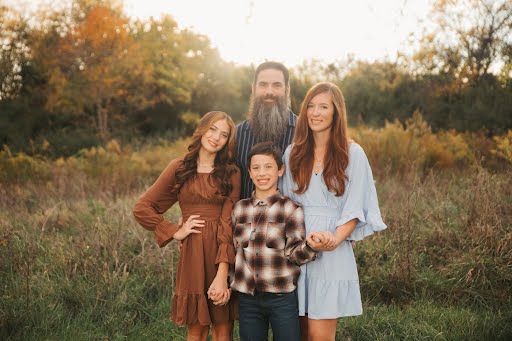 Michael Jividen with his family outdoors
